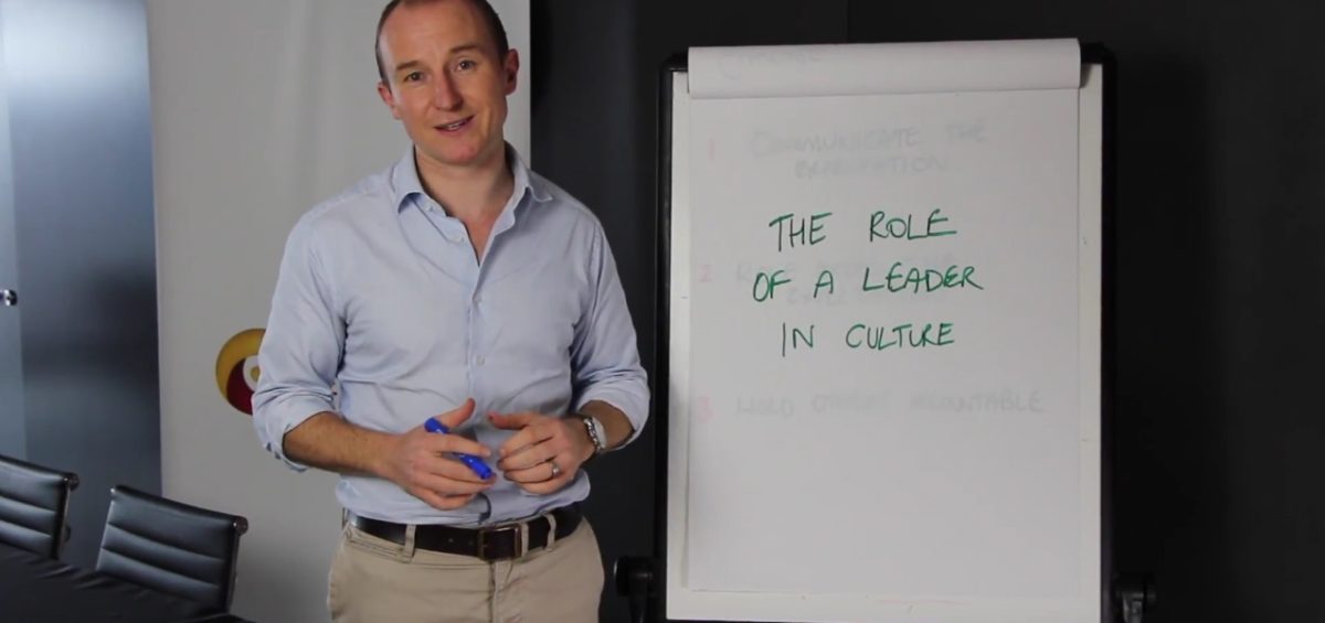 John Colbert giving presentation on The Role of a Leader in Company Culture